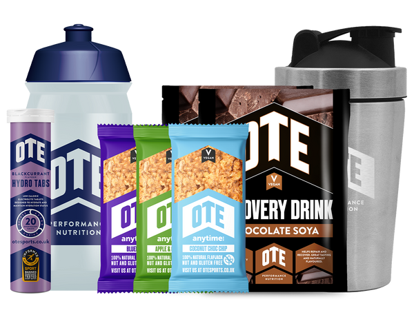 Collection of OTE Performance Nutrition products including a shaker, tabs, and packets on a white background.