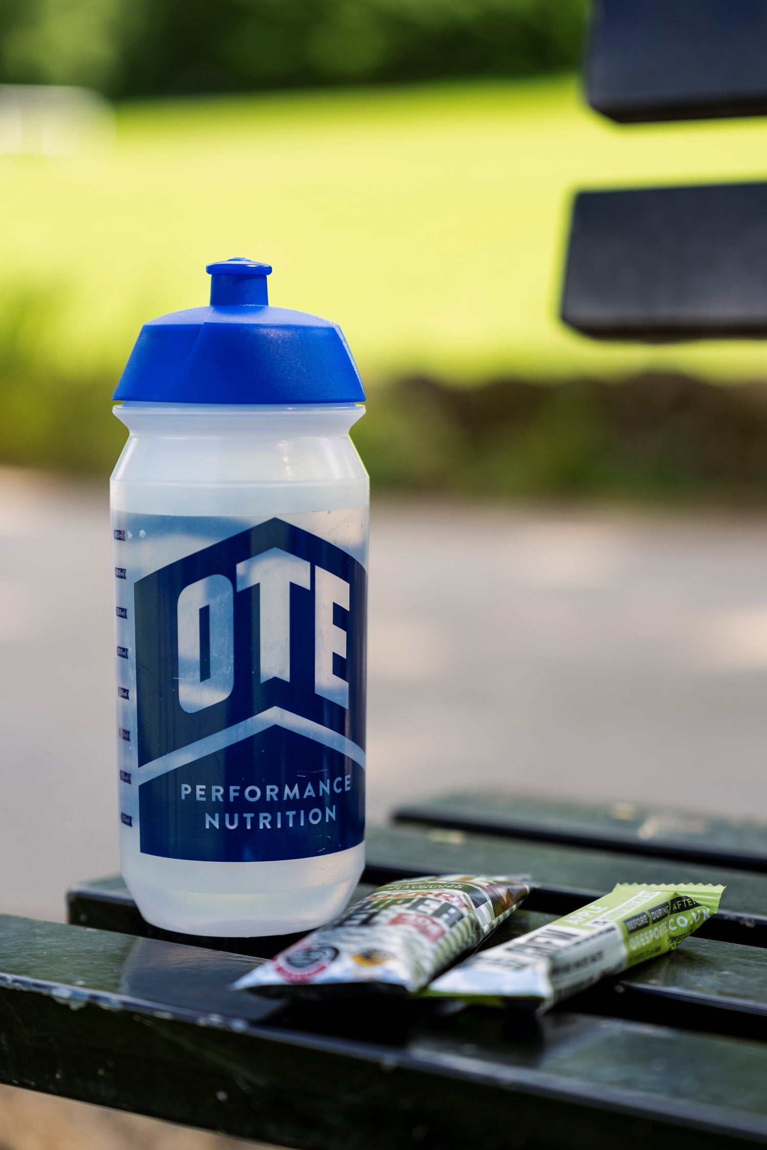 OTE Performance Nutrition water bottle on a table outdoors