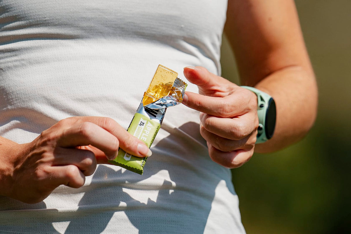 Person holding a snack bar with a blurred background