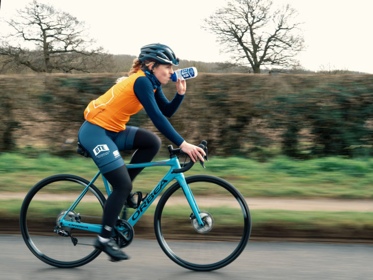 Athlete Hydrating on a Cycle