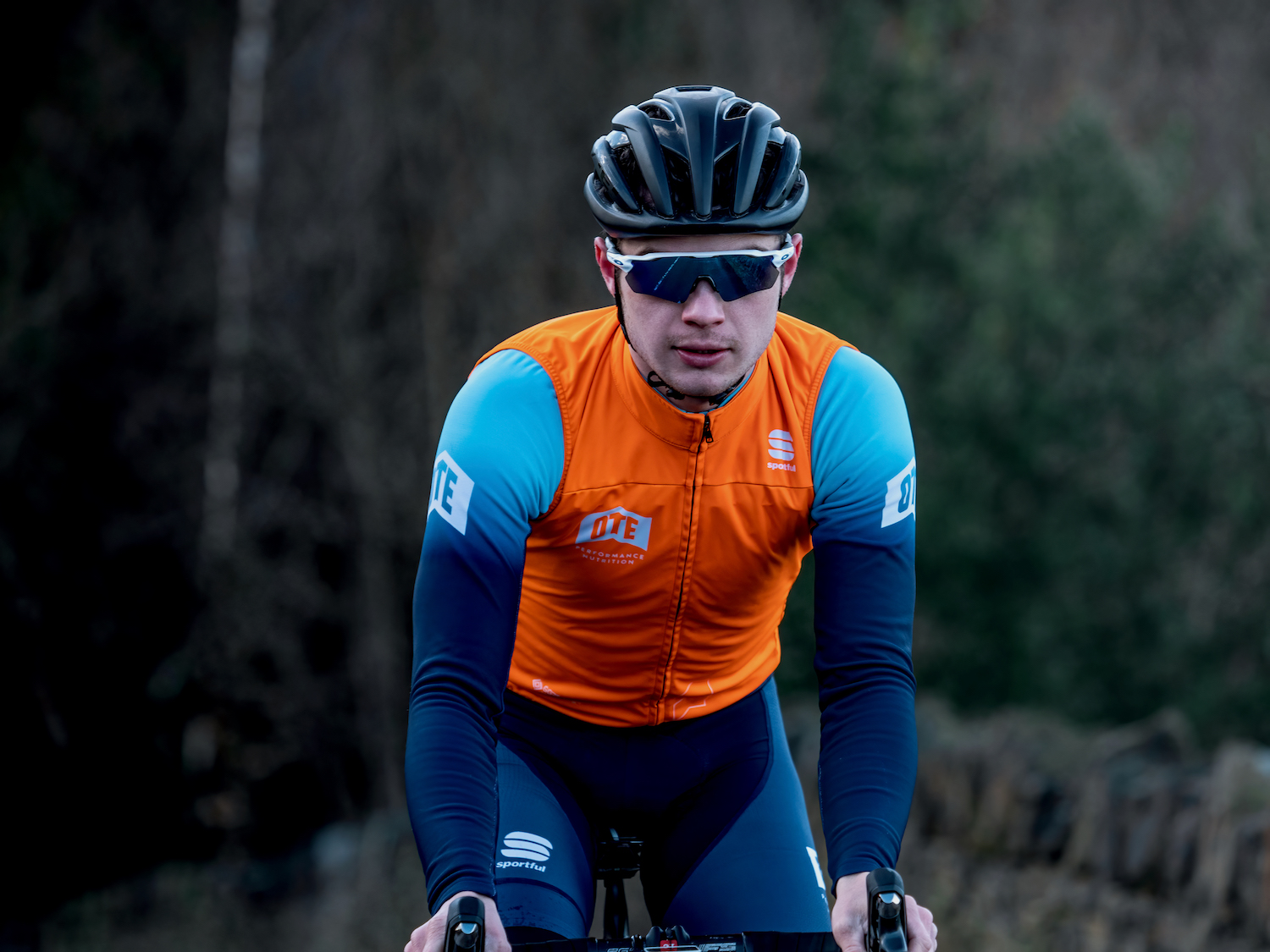 Cyclist wearing OTE Sports cycling gear.