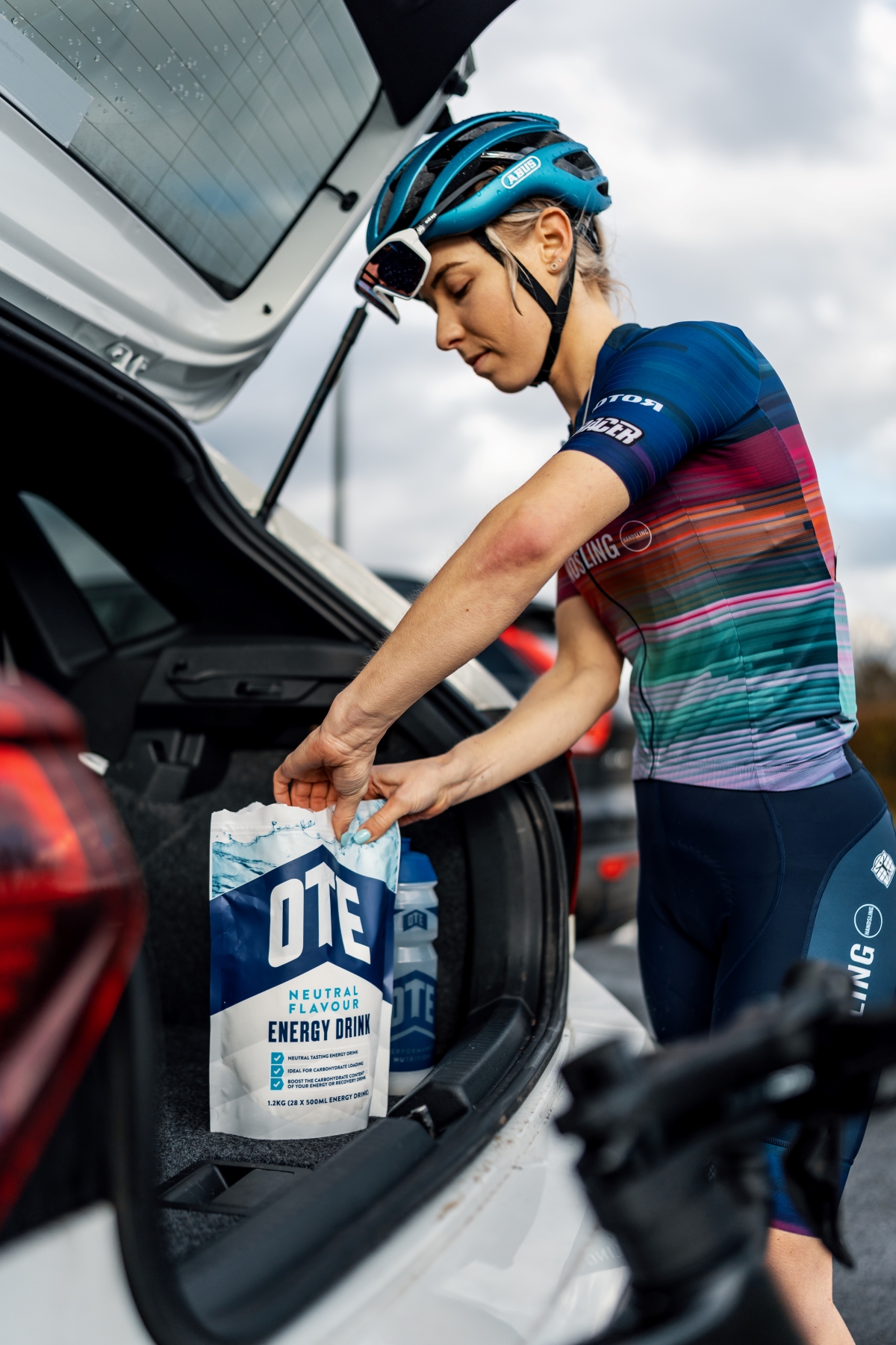 Triathlete refueling with OTE Sports hydration drink.