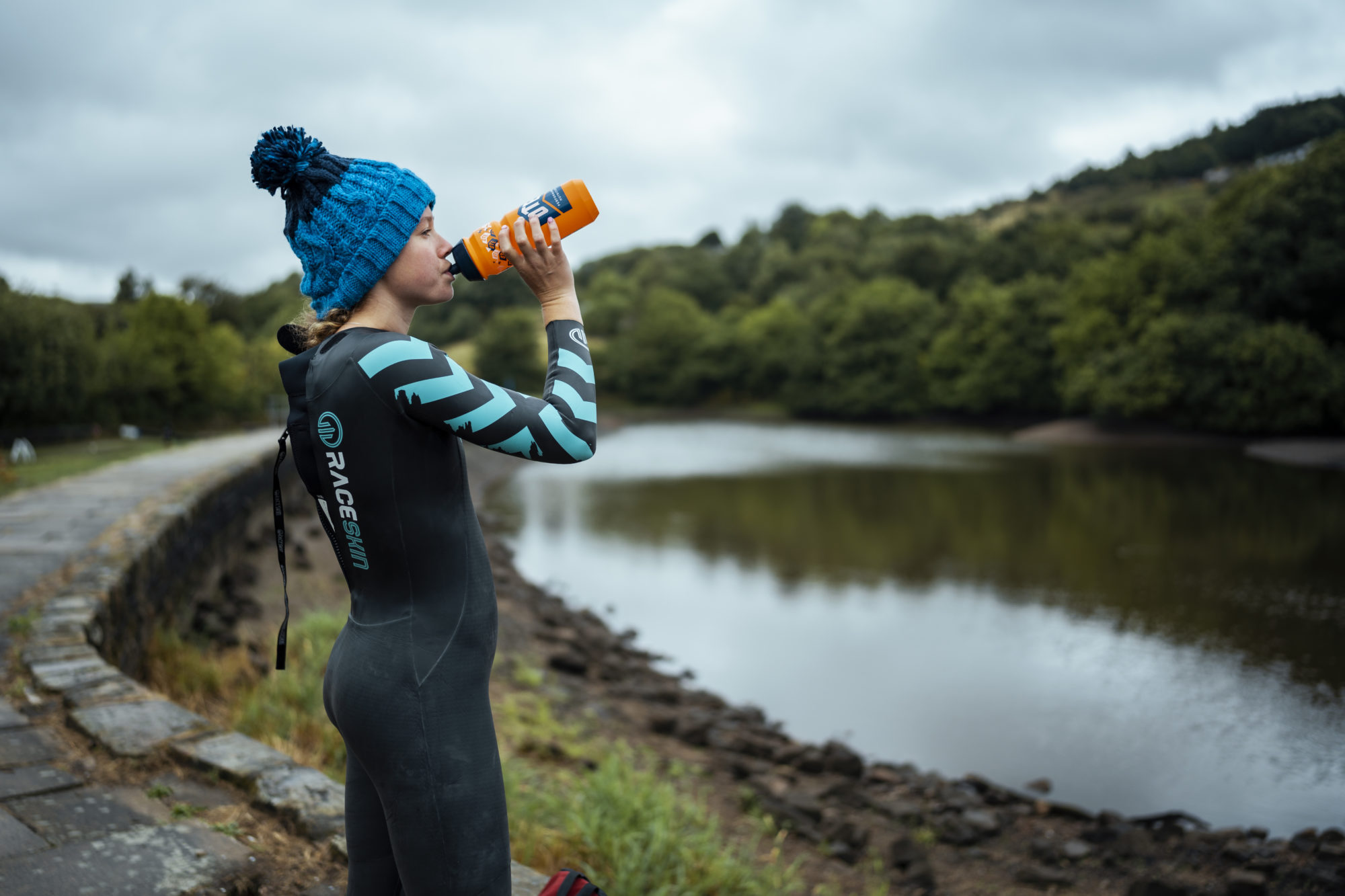 Athlete Drinking Out of Our Camo Sports Bottle Before an Open Water Swim