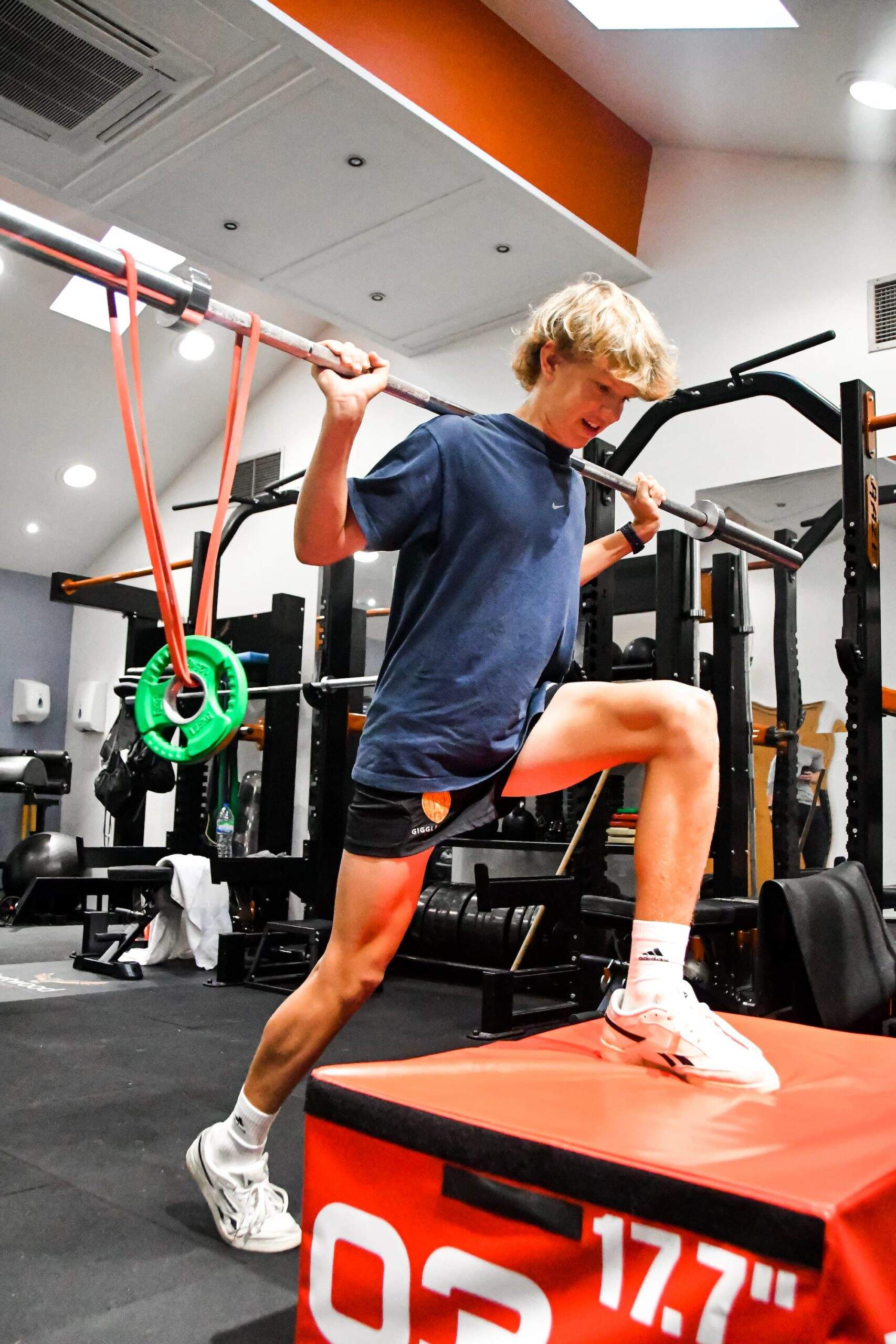 Individual lifting weights in a gym.