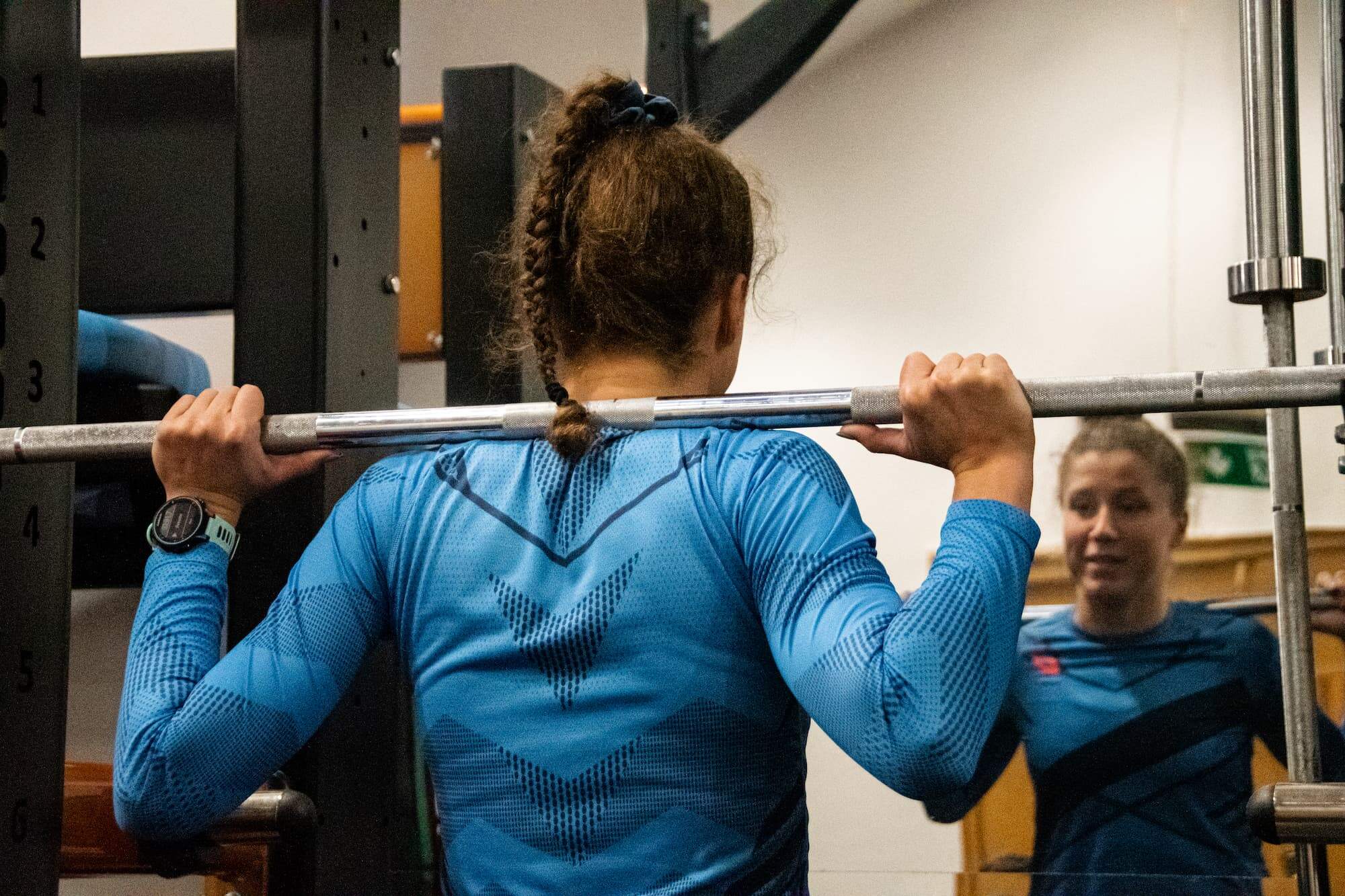 Woman lifting weights in a gym.