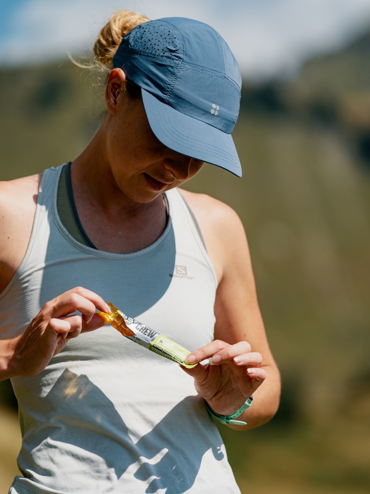 Runner holding an OTE Sports chew bar.