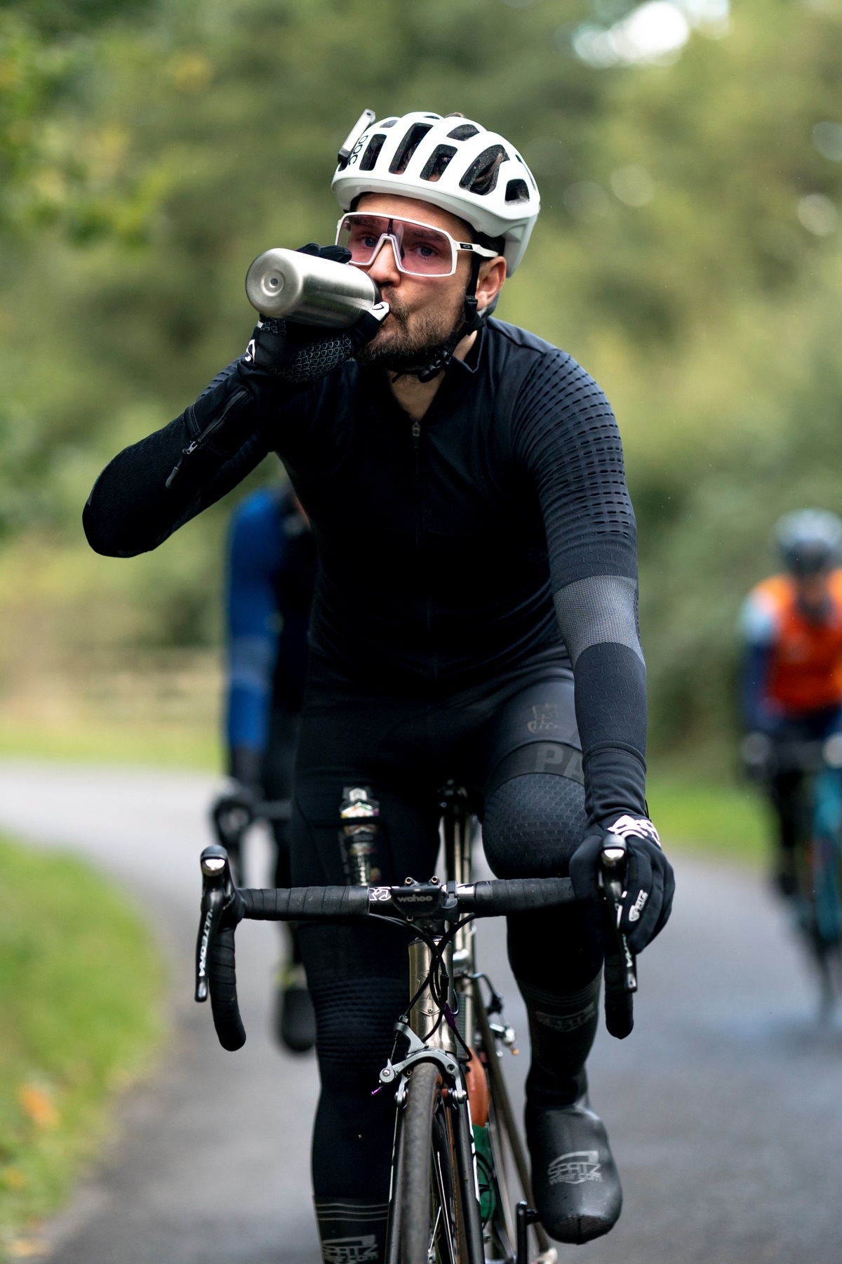 Cyclist drinking from an OTE Sports bottle